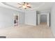 Spacious main bedroom featuring neutral colors, ceiling fan, and adjoining bathroom and walk-in closet at 44 Star Spangled Ln, Peachtree City, GA 30269