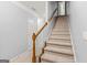 Carpeted staircase with white banister and wood railing, leads to the upper level of the home at 44 Star Spangled Ln, Peachtree City, GA 30269