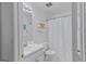 Well-lit bathroom featuring a white vanity, toilet, and a shower with a curtain at 1022 Gloria Grand Blvd, Mcdonough, GA 30252
