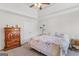 Cozy bedroom features a ceiling fan and a comfortable bed with floral accents at 1022 Gloria Grand Blvd, Mcdonough, GA 30252