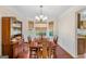 Traditional dining room featuring hardwood floors, a wooden table set, and natural light from the bay window at 1022 Gloria Grand Blvd, Mcdonough, GA 30252