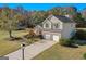 Charming two-story home with brick accents, two-car garage, and well-manicured lawn from an aerial view at 1022 Gloria Grand Blvd, Mcdonough, GA 30252