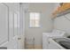 Functional laundry room with a washer, dryer, and overhead shelving for storage at 1022 Gloria Grand Blvd, Mcdonough, GA 30252