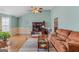 Cozy living room featuring a comfortable couch, rug, ceiling fan, and work area at 1022 Gloria Grand Blvd, Mcdonough, GA 30252