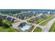Aerial view of a new housing development with a community pool, playground, and splash pad at 1724 Goodwin Dr # 74, Hampton, GA 30228