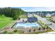 Aerial view showcasing the community's pool, playground, ample green space, and residential architecture at 1724 Goodwin Dr # 74, Hampton, GA 30228
