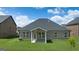 View of the brick and stone accented home, complemented by lush green grass at 1724 Goodwin Dr # 74, Hampton, GA 30228