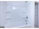 Clean white tub/shower combo features built-in shelves and a shower head at 1724 Goodwin Dr # 74, Hampton, GA 30228