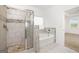 Bathroom featuring glass enclosed shower, soaking tub with tile accents, and view to a bright bedroom at 1724 Goodwin Dr # 74, Hampton, GA 30228