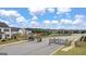 Gated entrance to a community with well-maintained landscaping and a paved street with neighborhood homes in the background at 1724 Goodwin Dr # 74, Hampton, GA 30228