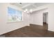 Open-concept dining room featuring hardwood floors, a modern chandelier, and ample natural light at 1724 Goodwin Dr # 74, Hampton, GA 30228