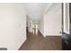 Inviting foyer with dark hardwood flooring offering a glimpse into the kitchen and living areas at 1724 Goodwin Dr # 74, Hampton, GA 30228