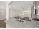 Open-concept kitchen with a large island featuring granite countertops, stainless steel appliances, and modern pendant lighting at 1724 Goodwin Dr # 74, Hampton, GA 30228
