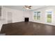 Open living room boasts hardwood floors, a cozy fireplace, and natural light from a glass door at 1724 Goodwin Dr # 74, Hampton, GA 30228