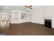 Expansive living room with a fireplace, hardwood flooring, and an open view to the modern kitchen at 1724 Goodwin Dr # 74, Hampton, GA 30228