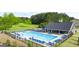 Community pool with a splash pad, clubhouse, playground, and plenty of lounge seating and umbrellas at 1724 Goodwin Dr # 74, Hampton, GA 30228