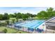 Community pool surrounded by lush greenery and lounge chairs for relaxing by the water at 1724 Goodwin Dr # 74, Hampton, GA 30228