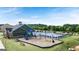 Community pool, clubhouse, splash pad, and playground with lounge seating and umbrellas at 1724 Goodwin Dr # 74, Hampton, GA 30228