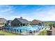 Community pool with a splash pad, clubhouse, playground, and plenty of lounge seating and umbrellas at 1724 Goodwin Dr # 74, Hampton, GA 30228