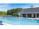 Community pool with a splash pad, playground, and lots of lounge seating and umbrellas at 1724 Goodwin Dr # 74, Hampton, GA 30228