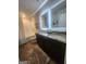 Bathroom featuring a double vanity with granite countertop, wood flooring, and a bathtub with shower at 4852 Station Lane # 19, Union City, GA 30349