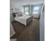Bright bedroom with plush carpet, a comfortable bed with soft pink accents, and lots of natural light at 4852 Station Lane # 19, Union City, GA 30349