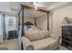 Elegant bedroom featuring a four-poster bed, sitting area, and soft natural light at 141 Whistle Way, Locust Grove, GA 30248