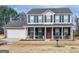 Charming two-story brick home with black shutters and a welcoming front porch at 141 Whistle Way, Locust Grove, GA 30248