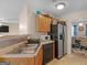 Efficient kitchen featuring stainless steel refrigerator, black dishwasher, and natural wood cabinets at 141 Whistle Way, Locust Grove, GA 30248