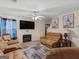 Cozy living room with a fireplace, plush couches, ceiling fan and a TV for relaxation and entertainment at 141 Whistle Way, Locust Grove, GA 30248