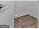 Walk-in closet showing built-in shelving and wood look flooring at 4856 Station Ln # 21, Union City, GA 30349
