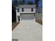 Two-story home featuring a two-car garage, a dark front door, and a long concrete driveway at 4856 Station Ln # 21, Union City, GA 30349