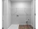 Bright laundry room boasts modern white walls, wood look flooring, and built-in shelving at 4856 Station Ln # 21, Union City, GA 30349