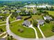 Aerial view of a residential area showcasing homes, green lawns, and a serene lake at 550 Wentworth Ct, Fayetteville, GA 30215