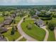Aerial shot of a suburban neighborhood, featuring well-maintained homes and lush green lawns at 550 Wentworth Ct, Fayetteville, GA 30215
