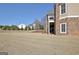 The backyard features a spacious lawn, neatly trimmed shrubs, and views of neighboring houses at 550 Wentworth Ct, Fayetteville, GA 30215