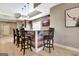 Finished basement features a bar with wood accents, granite counters, and seating for entertaining at 550 Wentworth Ct, Fayetteville, GA 30215
