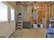 Unfinished basement storage space with a utility door, ladder, and open stud walls at 550 Wentworth Ct, Fayetteville, GA 30215
