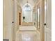 Elegant bathroom featuring a luxurious soaking tub, chandelier, travertine tile floor and neutral decor at 550 Wentworth Ct, Fayetteville, GA 30215
