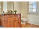 Traditional powder room featuring custom vanity with dark countertop and decorative mirror at 550 Wentworth Ct, Fayetteville, GA 30215