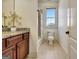 Bright bathroom features a wooden vanity with granite countertop and shower with tub at 550 Wentworth Ct, Fayetteville, GA 30215