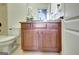 Bathroom vanity with granite countertop, wooden cabinets, and decorative floral arrangement at 550 Wentworth Ct, Fayetteville, GA 30215