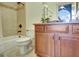 Bathroom boasts a vanity, shower with decorative tile, and an abundance of natural light at 550 Wentworth Ct, Fayetteville, GA 30215