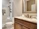Bathroom with marble vanity, bronze hardware, and a glass enclosed shower with shelving at 550 Wentworth Ct, Fayetteville, GA 30215