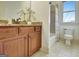Well-lit bathroom with wood vanity, granite countertop, and a shower-tub combo at 550 Wentworth Ct, Fayetteville, GA 30215