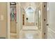 Bathroom featuring a walk-in closet, luxurious soaking tub, chandelier, travertine tile floor and neutral decor at 550 Wentworth Ct, Fayetteville, GA 30215