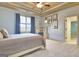Well-lit bedroom featuring light blue walls and a window with blue curtains at 550 Wentworth Ct, Fayetteville, GA 30215
