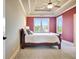 Bedroom features a tray ceiling, ceiling fan, and large windows offering scenic views at 550 Wentworth Ct, Fayetteville, GA 30215