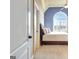 A charming bedroom features a large arched window with a ceiling fan and a comfortable queen bed at 550 Wentworth Ct, Fayetteville, GA 30215