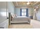 Bright bedroom featuring a tray ceiling, ceiling fan, and a charming built-in desk area at 550 Wentworth Ct, Fayetteville, GA 30215